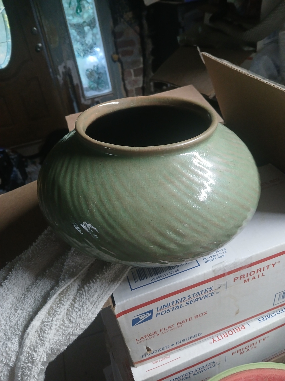 an antique Chinese celadon green-glazed ovoid stoneware jar or jardiniere